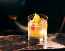 A Whiskey Sour against a dark surface