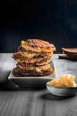 A stack of potato fritters with apple sauce