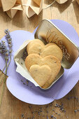 Heart-shaped, gluten-free lavender shortbread biscuits in a biscuit tin