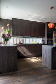 Elegant kitchen with dark wooden fronts