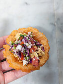 Salbutes topped with chicken, red cabbage and salsa