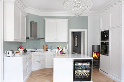 White fitted kitchen with island counter