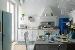 Set breakfast table in white country-house kitchen