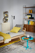 Couch, String shelves and yellow accents in living room