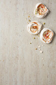 Guava-rippled meringues topped with pistachios