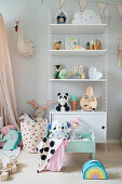 Cute children's accessories on shelves in girl's bedroom in pastel shades