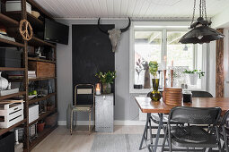 Dining table and folding chairs, large chalkboard and rusty metal shelving