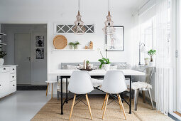 Shell chairs at table in Scandinavian-style dining room
