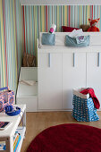 Loft bed with steps and storage cupboards in children's bedroom