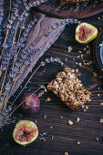 Figs oat bars on a rustic dark wooden table