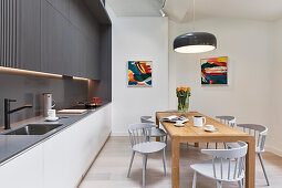Dining area and fitted kitchen in bright, open-plan interior