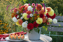 Bouquet of dahlias, zinnias, Helenium, knotweed, and aster, plate with sliced cantalope