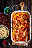 Chicken drumsticks baked with pumpkin and cherry tomatoes