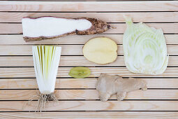 Flatlay of nutritious white fruits and vegetables arranged on a wooden background
