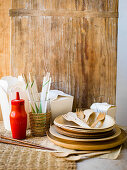 Take out containers, chopsticks, a ketchup bottle, wooden plates and cutlery