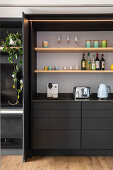 Charcoal-grey kitchen cabinet element with pocket doors