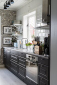 Black cabinets in kitchen in Scandinavian country-house style