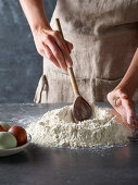 Preparing pasta dough: create a well in a pile of flour