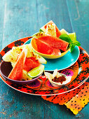 Slices of watermelon and bowl of chillies