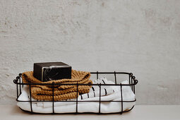 Cloths, knitted cloth and soap in small wire basket