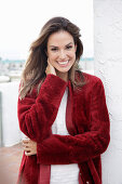 A young woman wearing a red coat