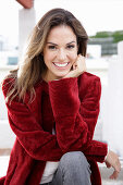 A young woman wearing a red coat