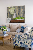 Blue-and-white armchair and ecru sofa in living room