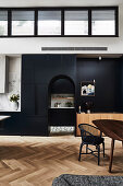 High, open living room with black fixtures and arched neckline