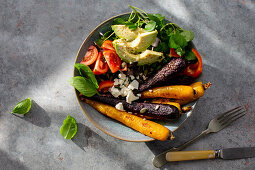 Vegetable bowl with roasted carrots, avocado and feta