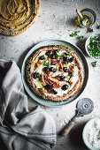 Sweet potato pizza with olives, ricotta and prosciutto