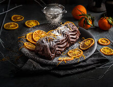Chocolate log with hints of orange orange peel with icing sugar dusting