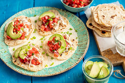 Home made tortillas with shredded cooked chicken, avo and tomato salsa