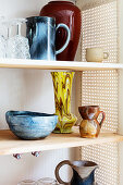 Retro stoneware crockery in refurbished cupboard