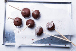 Vegan cakepops with rice milk chocolate and grated coconut