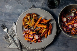 Spicy cauliflower 'steak' with red cabbage salad and sweet potato fries