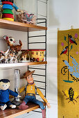 Old toys on String shelves in child's bedroom