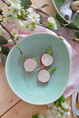 Radishes cut in half on a plate