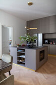 Island counter and golden baseboards in grey modern kitchen