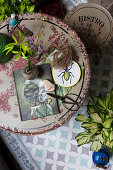 Various decorative items on round, vintage balcony table