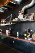 Kitchen in loft apartment with black wall