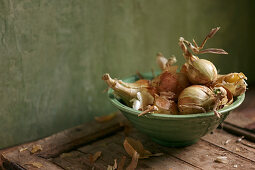 Onions in a green ceramic bowl