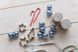 Candy canes, blue baubles, candles and pastry cutters