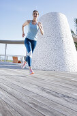 A brunette woman jogging