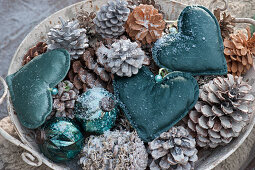 Bowl with hearts, cones and balls as Christmas decoration