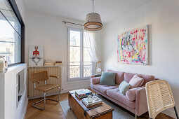 Pink sofa in small, eclectic living room