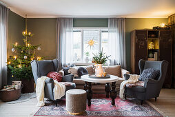 Wing-back armchairs and Christmas tree in cosy living room
