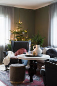 Wing-back armchairs and Christmas tree in cosy living room