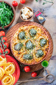 Pasta nests with meatballs, pesto and tomato cream sauce