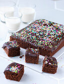 Chocolate tray bake cake with chocolate glaze and sprinkles