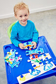 Little boy with hand-painted jigsaw